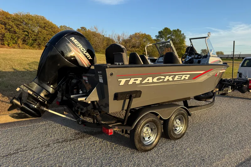 Slide: The Image of 2018 Tracker Targa 18 WT boat on a road, surrounded by trees. - 27
