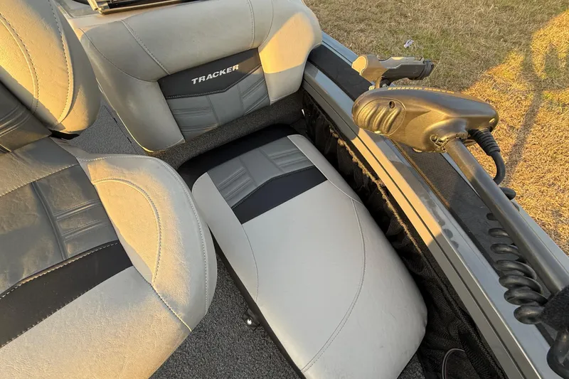 Slide: The Image of 2018 Tracker Targa 18 WT interior with gray carpet and storage compartment. - 38