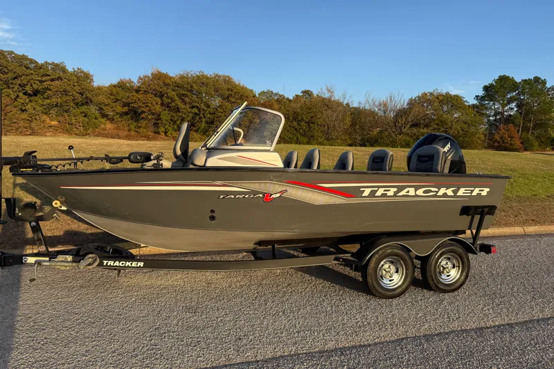 Slide: The Image of 2018 Tracker Targa 18 WT boat on trailer, parked on a road with grassy background. - 4