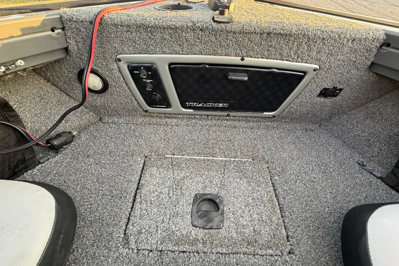 Slide: The Image of 2018 Tracker Targa 18 WT boat interior with cushioned seating and storage compartment. - 42