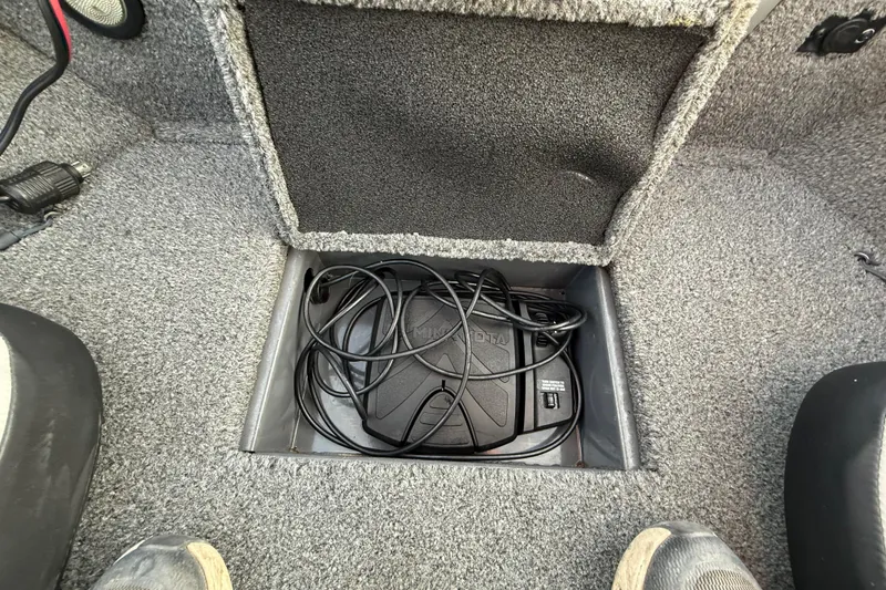 Slide: The Image of 2018 Tracker Targa 18 WT boat storage compartment with gray interior. - 43