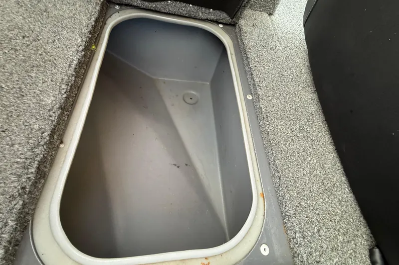 Slide: The Image of 2018 Tracker Targa 18 WT boat interior with gray seating and carpeted flooring. - 46