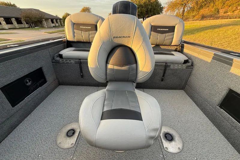 Slide: The Image of 2018 Tracker Targa 18 WT boat interior with cushioned seats and motor view. - 49