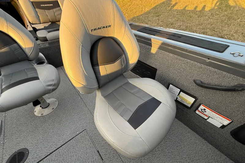 Slide: The Image of 2018 Tracker Targa 18 WT boat dashboard with steering wheel at sunset. - 50