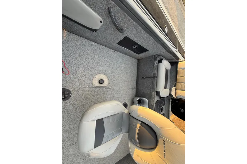 Slide: The Image of 2018 Tracker Targa 18 WT boat storage compartment with latch, carpeted interior. - 61