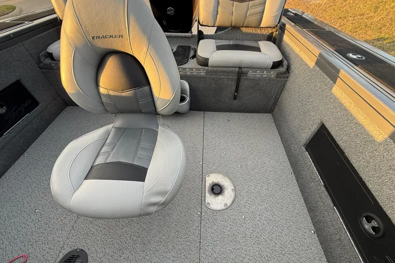Slide: The Image of 2018 Tracker Targa 18 WT boat storage compartment with carpeted interior and cup holders. - 62