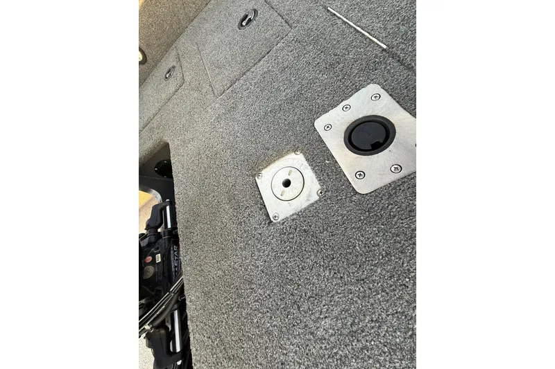 Slide: The Image of 2018 Tracker Targa 18 WT boat interior with seating and dashboard, parked on grass. - 78