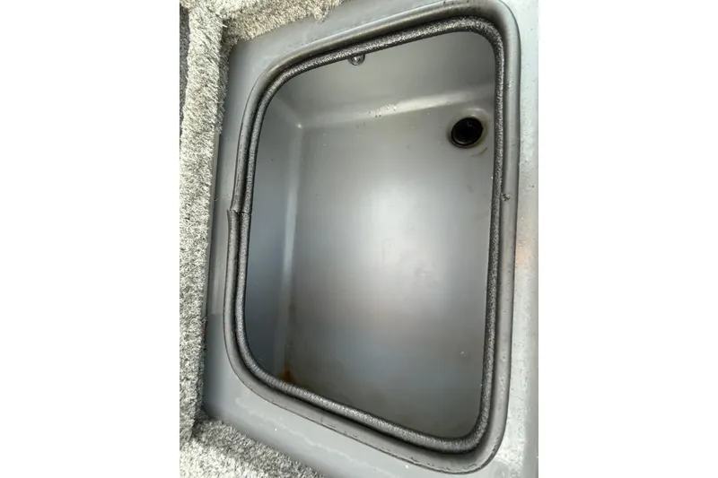 Slide: The Image of 2018 Tracker Targa 18 WT boat interior with Mercury engine, featuring seating and control panel. - 79