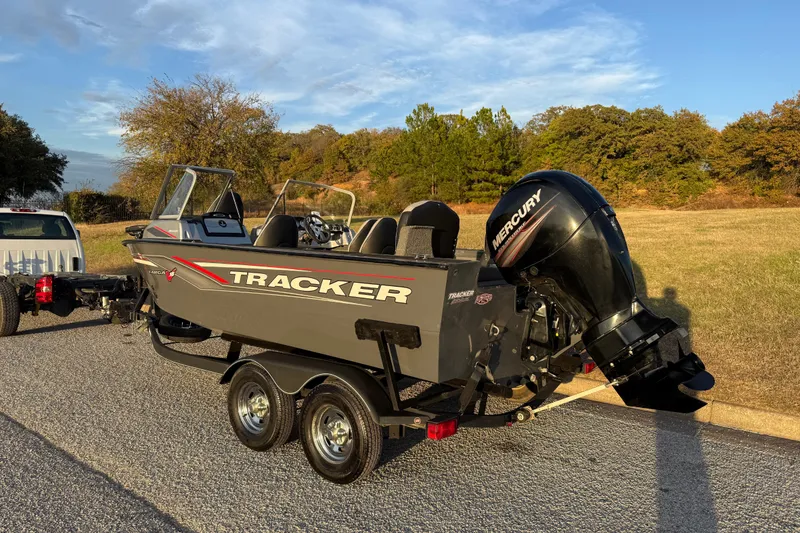 Slide: The Image of 2018 Tracker Targa 18 WT boat on trailer, parked on roadside under clear sky. - 9