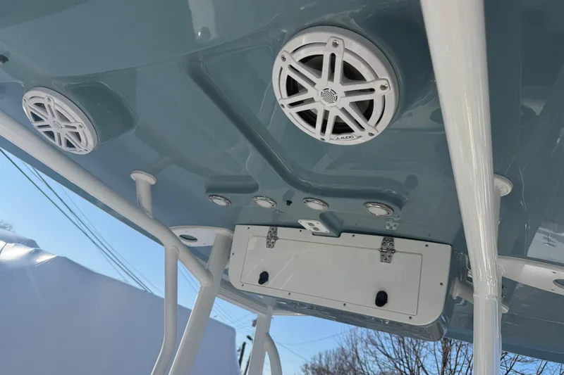 Slide: The Image of 2026 Sea Hunt Ultra 234 boat speakers and storage compartment on the ceiling. - 14
