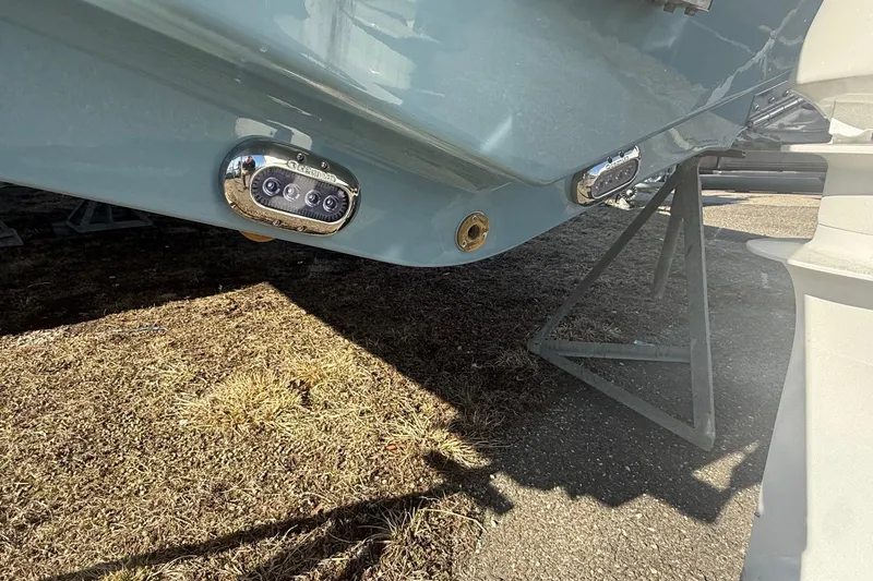 Slide: The Image of 2026 Sea Hunt Ultra 234 boat hull with underwater lights and support stand. - 18