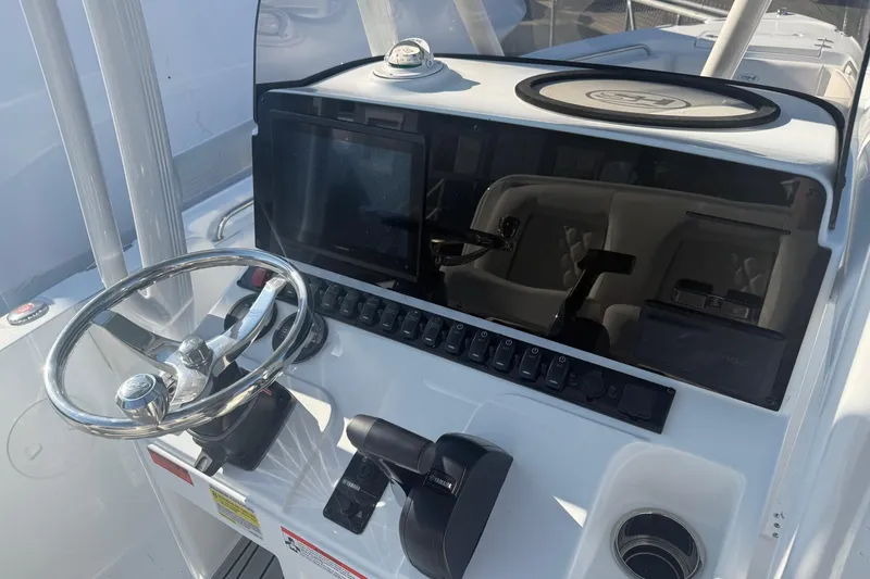 Slide: The Image of 2026 Sea Hunt Ultra 234 boat dashboard with steering wheel and control panel. - 19