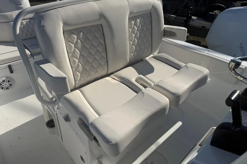 Slide: The Image of 2026 Sea Hunt Ultra 234 boat with white cushioned seating and diamond stitching. - 23