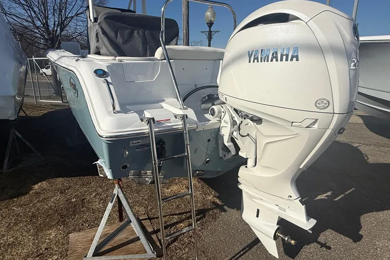 Slide: The Image of 2026 Sea Hunt Ultra 234 boat with Yamaha outboard motor, parked on a stand. - 4