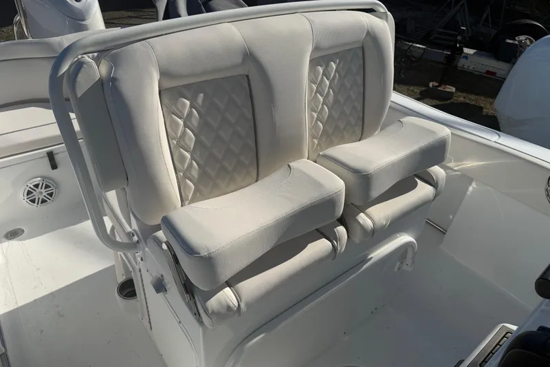 Slide: The Image of 2026 Sea Hunt Ultra 234 boat seating with white cushioned upholstery. - 5