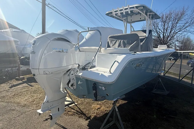 Slide: The Image of 2026 Sea Hunt Ultra 234 boat with Yamaha outboard motor, displayed outdoors. - 6