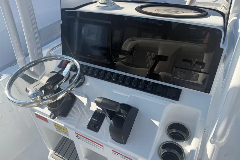 Slide: The Image of 2026 Sea Hunt Ultra 234 boat dashboard with steering wheel and control panel. - 8