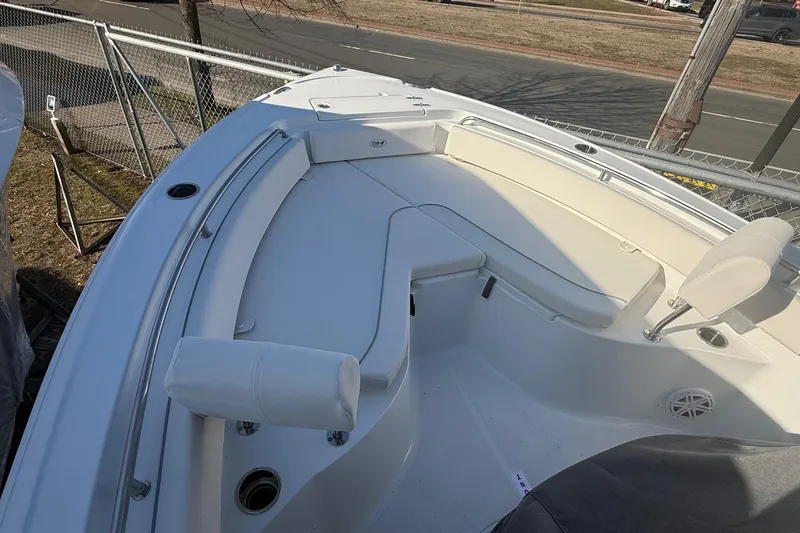 Slide: The Image of 2026 Sea Hunt Ultra 234 boat interior with white seating and cup holders. - 9