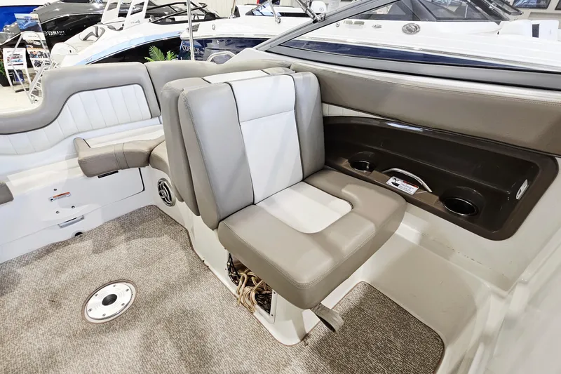 Slide: The Image of 2009 Yamaha Boats 232 Limited interior seating with gray upholstery and cup holders. - 11