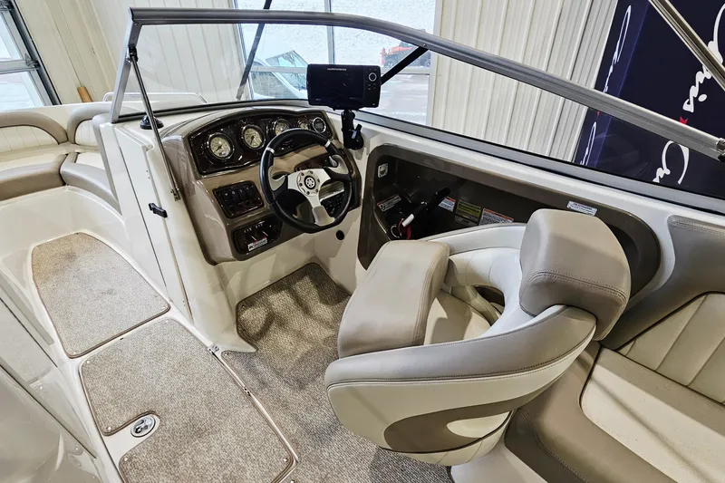 Slide: The Image of 2009 Yamaha Boats 232 Limited cockpit with steering wheel and dashboard controls. - 13