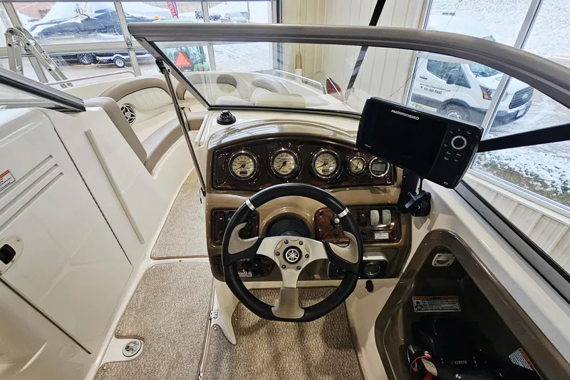 Slide: The Image of 2009 Yamaha Boats 232 Limited dashboard with steering wheel and navigation system. - 14