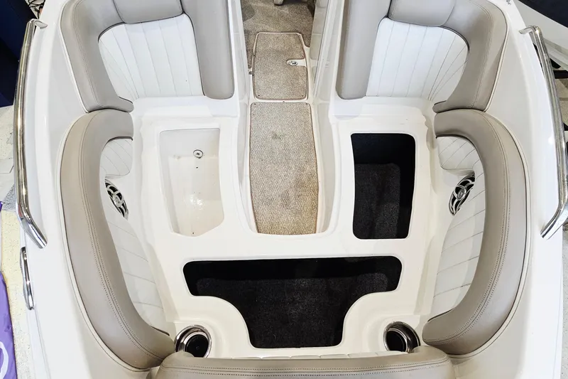 Slide: The Image of 2009 Yamaha Boats 232 Limited interior with beige seating and storage compartments. - 20