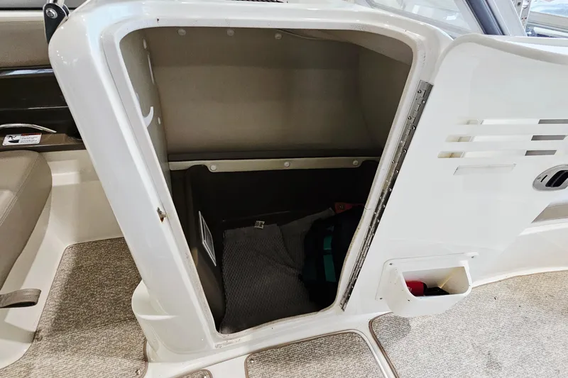 Slide: The Image of 2009 Yamaha Boats 232 Limited storage compartment with open door, showcasing interior space. - 22