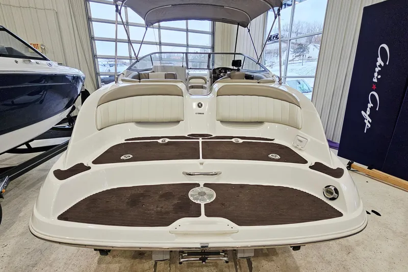 Slide: The Image of 2009 Yamaha Boats 232 Limited in showroom, rear view with seating and deck. - 6