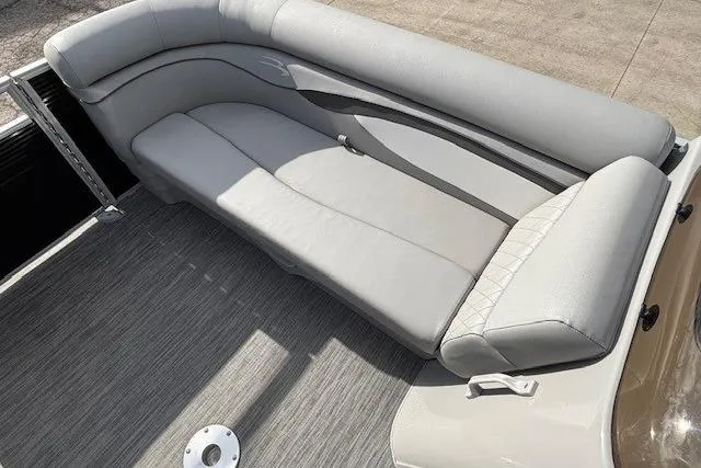 Slide: The Image of 2022 Bennington S 22 Quad Bench with gray cushioned seating on a boat deck. - 10