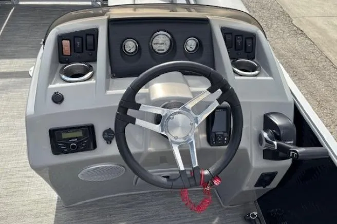 Slide: The Image of 2022 Bennington S 22 Quad Bench boat dashboard with steering wheel and controls. - 16