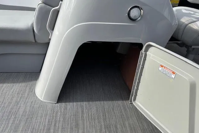 Slide: The Image of 2022 Bennington S 22 Quad Bench storage compartment with open hatch on boat deck. - 19
