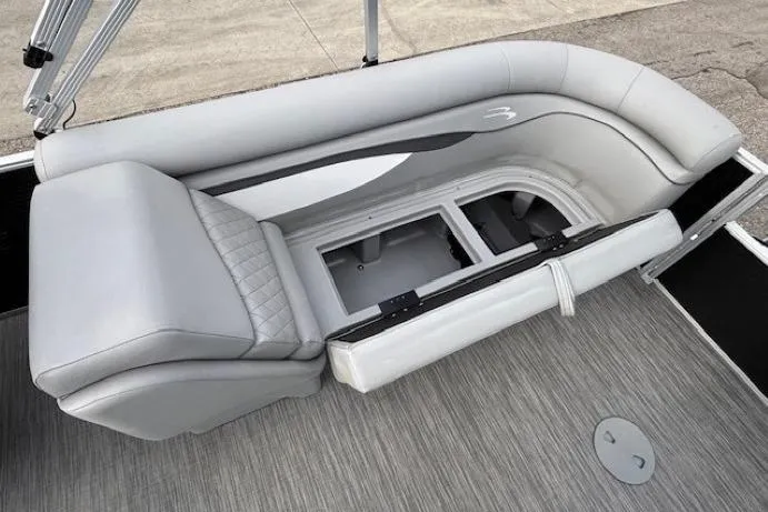 Slide: The Image of 2022 Bennington S 22 Quad Bench with open storage compartment on a pontoon boat. - 28
