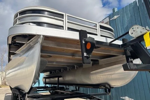 Slide: The Image of 2022 Bennington S 22 Quad Bench pontoon boat on trailer, viewed from below. - 3