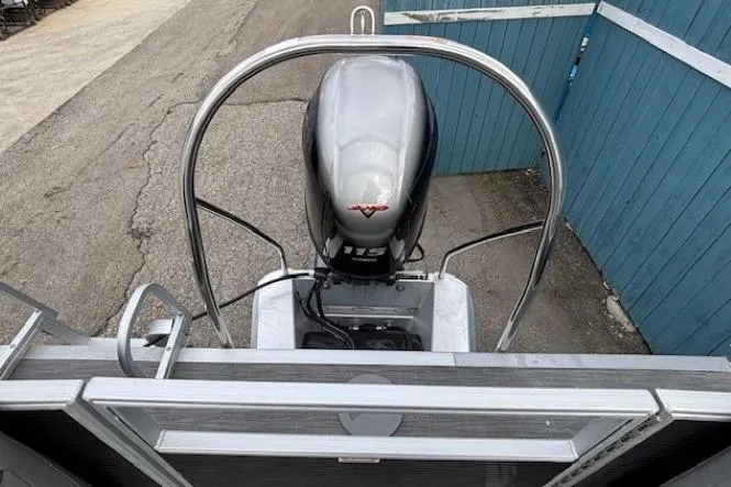 Slide: The Image of 2022 Bennington S 22 Quad Bench boat with outboard motor, docked near blue fence. - 30