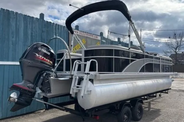 Slide: The Image of 2022 Bennington S 22 Quad Bench pontoon boat with Yamaha engine on trailer. - 4