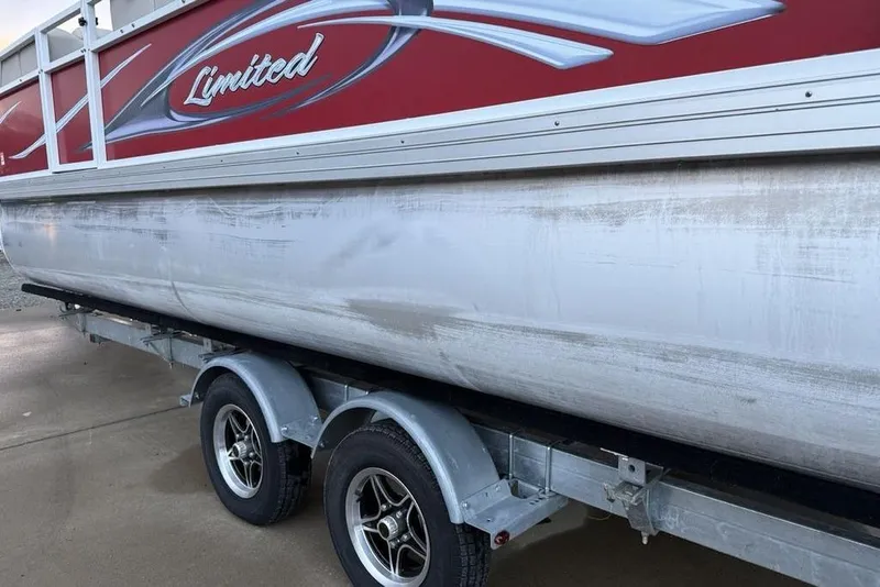 Slide: The Image of 2014 JC NepToon 24 Limited pontoon boat on trailer, red and silver design. - 12