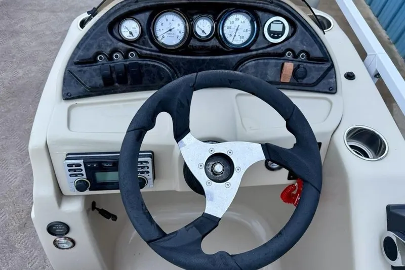 Slide: The Image of Steering console of 2014 JC NepToon 24 Limited pontoon boat with gauges and controls. - 14