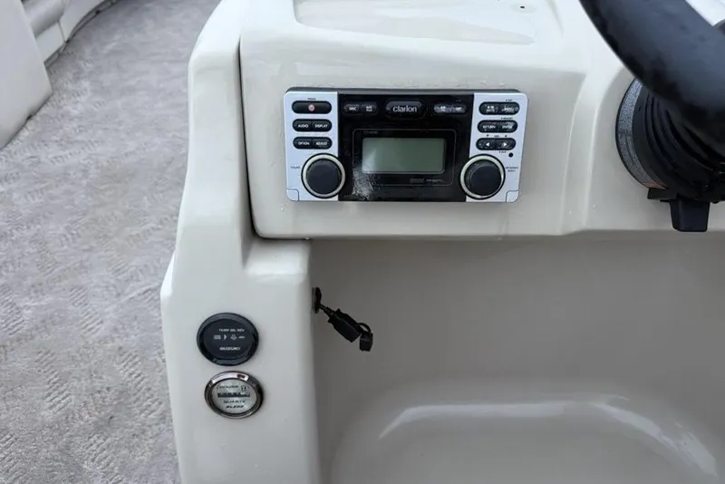 Slide: The Image of 2014 JC NepToon 24 Limited dashboard with Clarion stereo system and controls. - 19