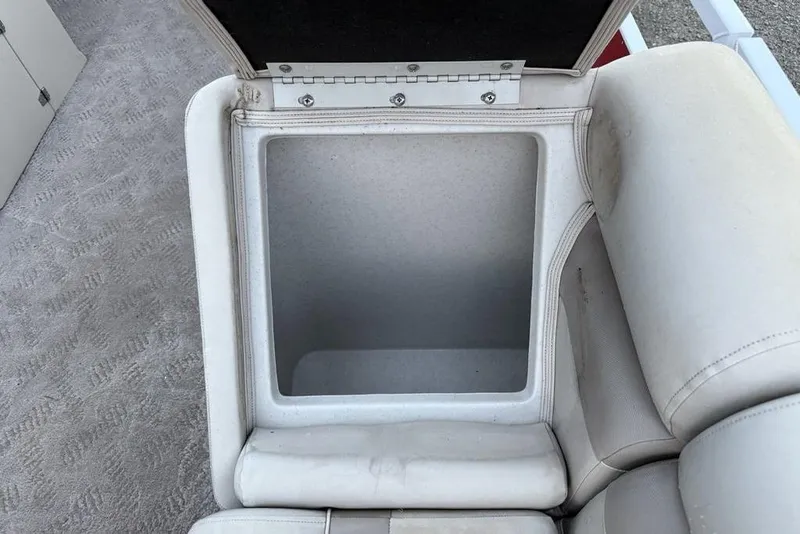 Slide: The Image of Open storage compartment in JC NepToon 24 Limited boat, 2014 model, with beige upholstery. - 5