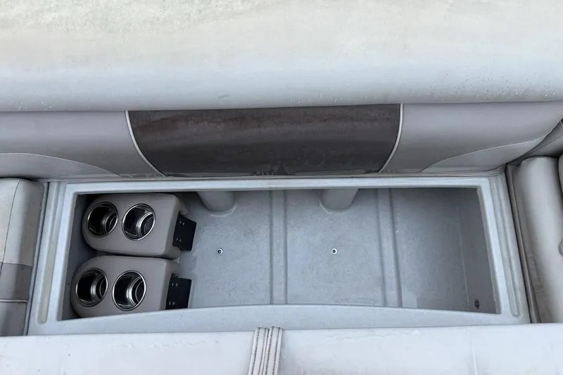 Slide: The Image of 2014 JC NepToon 24 Limited boat storage compartment with cup holders. - 6