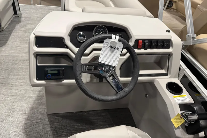 Slide: The Image of 2025 Godfrey Xperience 2086 SBX boat dashboard with steering wheel and control panel. - 6