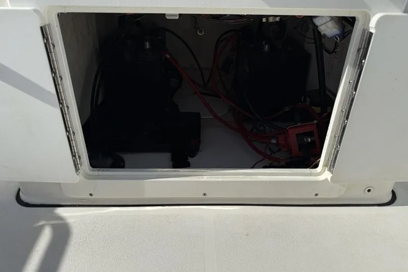 Slide: The Image of Open compartment of a 2020 Sea Pro 172 Bay boat showing internal wiring and components. - 17