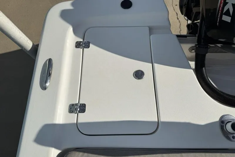 Slide: The Image of 2020 Sea Pro 172 Bay boat deck with storage compartment and engine details. - 19