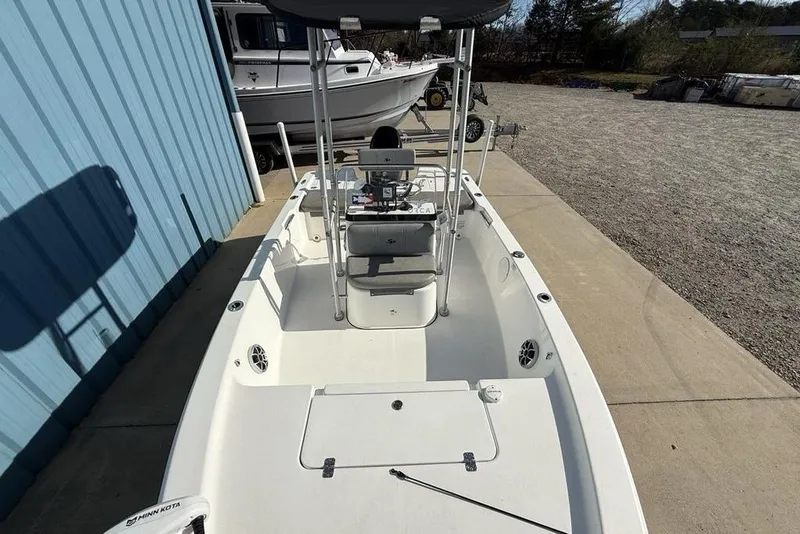 Slide: The Image of 2020 Sea Pro 172 Bay boat docked beside a blue building. - 22