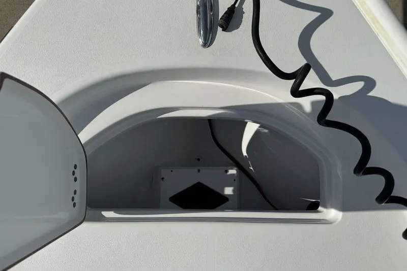 Slide: The Image of Open storage compartment on a 2020 Sea Pro 172 Bay boat, featuring a coiled cable. - 4