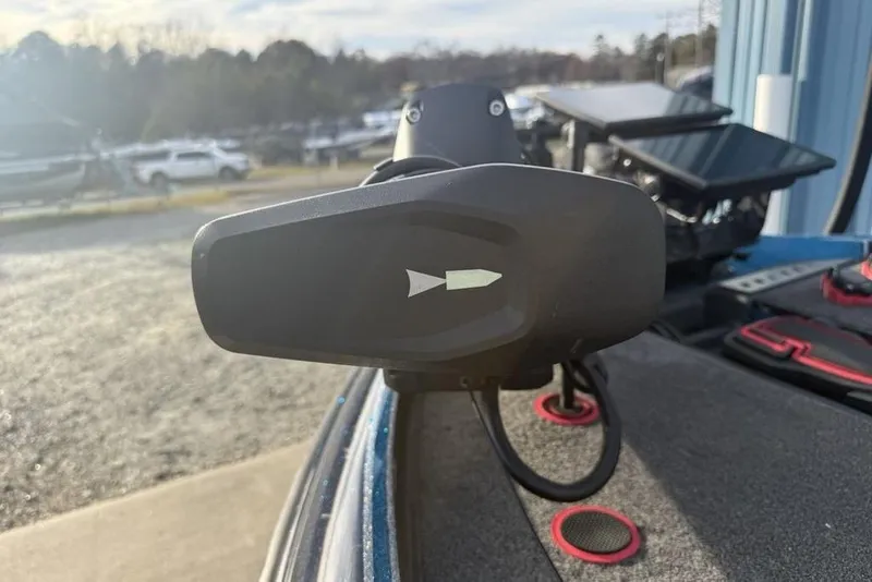 Slide: The Image of Close-up of a 2021 Triton 21 TrX boat's trolling motor in a sunny outdoor setting. - 11
