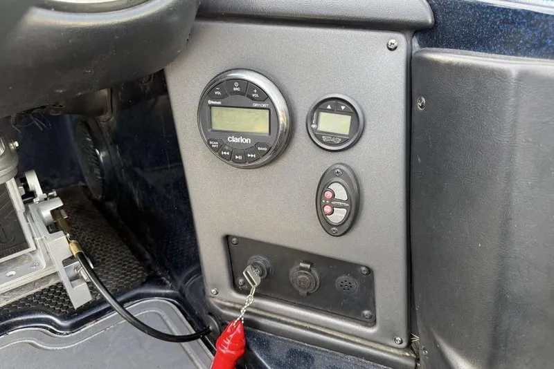 Slide: The Image of Control panel of a 2021 Triton 21 TrX boat featuring Clarion audio system. - 16