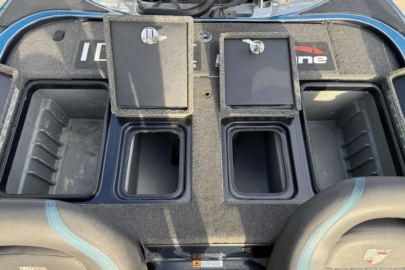Slide: The Image of 2021 Triton 21 TrX boat storage compartments with open lids and seating area. - 21