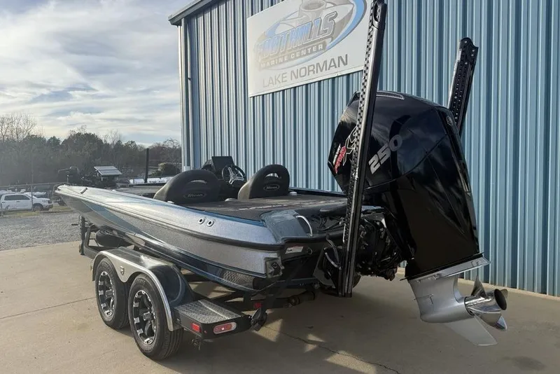 Slide: The Image of 2021 Triton 21 TrX boat with powerful 250 engine, parked at Lake Norman facility. - 5
