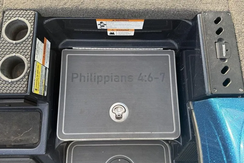Slide: The Image of 2021 Triton 21 TrX boat interior with cup holders and "Philippians 4:6-7" inscription. - 9